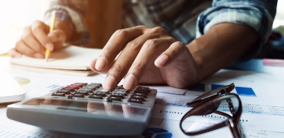 Man using a calculator in his office