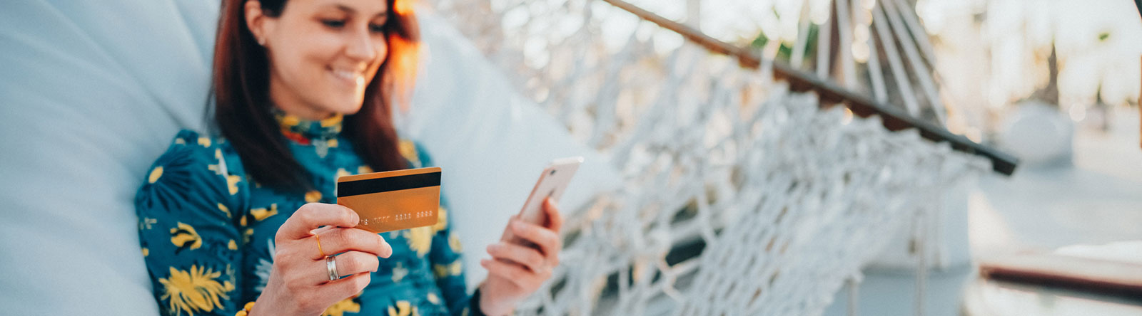 Lady using a credit card on her smartphone