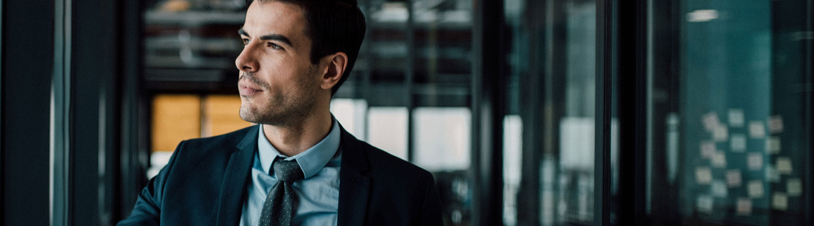 Businessman looking out an office window